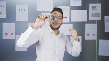 Man looking through magnifying glass. video