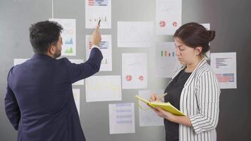 Manager examining company charts. video