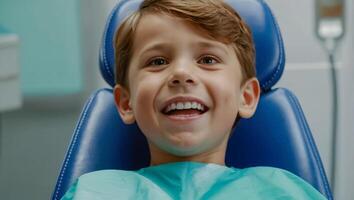 little boy happy in dental chair in clinic photo