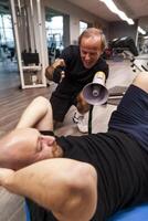 senior trainer screaming with a megaphone at the young athlete photo