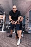 two friends athletes have fun while exercising at the cables photo