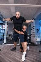 two friends athletes have fun while exercising at the cables photo