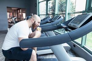 runner athlete relaxing eating an ice cream on the driving machinery photo