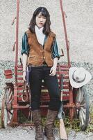 Portrait of a beautiful armed Chinese female cowgirl photo