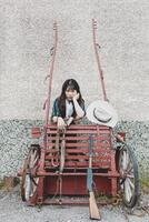 Portrait of a beautiful armed Chinese female cowgirl photo