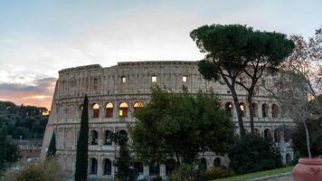 Panoramic view of the Colosseum amphitheater in Rome at sunset photo