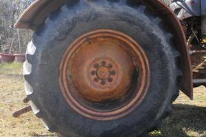 Tractor With Equipment Sitting In A Meadow. photo