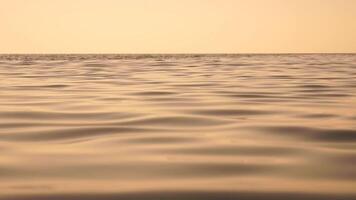 Sea water surface. Low angle view from kayak, camera flies over clear sea water. Nobody. Holiday recreation concept. Abstract nautical summer ocean nature. Slow motion. Close up. Vertical video