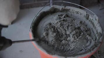 cement mortar is stirred in a bucket video