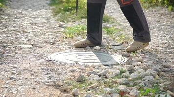 Manhole, Open, Worker - Man opens sewer manhole on gravel road maintenance work conducted for system inspection. video