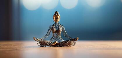 Woman in yoga pose, bent wire figure on blue backdrop, Creative figures symbol of yoga and harmony, art and serenity intersection. Female fitness yoga routine concept. Healthy lifestyle. photo