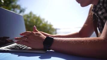 Woman laptop sea. Working remotely on seashore. Happy successful woman female freelancer working on laptop by the sea at sunset, makes a business transaction online. Freelance, remote work on vacation video