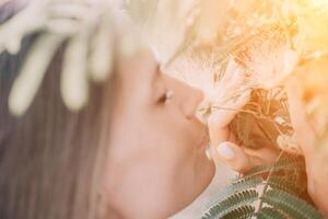 Beauty portrait of happy woman closeup. Young girl smelling Chinese acacia pink blossoming flowers. Portrait of young woman in blooming spring, summer garden. Romantic vibe. Female and nature photo