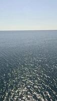 Sea water surface. Aerial view, camera flies over clear sea water. Nobody. Holiday recreation concept. Abstract nautical summer ocean nature. Slow motion. Close up. Vertical video