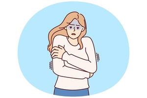 Freezing woman hugging shoulders trying to keep warm and feeling chills after contracting flu vector