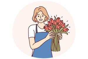 Positive woman flower seller stands with luxurious bouquet and smiling looks at camera vector