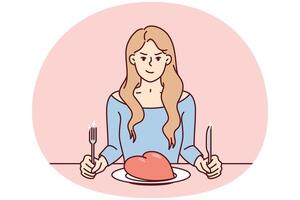 Frowning woman sits at table with giant heart in plate and holds fork with knife. image vector