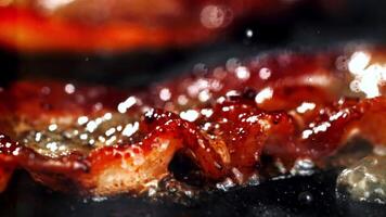 Super slow motion Bacon is fried in a pan. High quality FullHD footage video