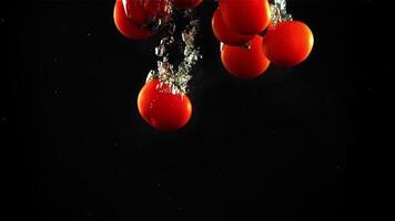 Tomaten fallen unter das Wasser mit Luft Blasen. auf ein schwarz Hintergrund.gefilmt ist schleppend Bewegung 1000 Frames pro zweite. hoch Qualität fullhd Aufnahmen video