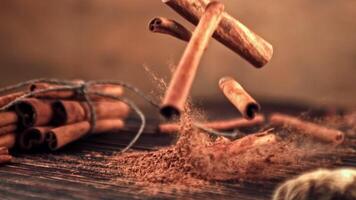 Super slow motion in a pile on the table falling cinnamon sticks. High quality FullHD footage video