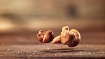 Super slow motion cashews fall on the table. High quality FullHD footage video