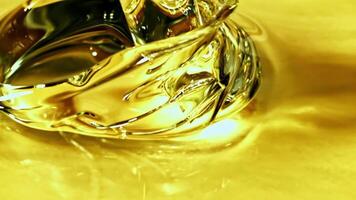 Super slow motion olive oil pours in a stream with splashes. High quality FullHD footage video