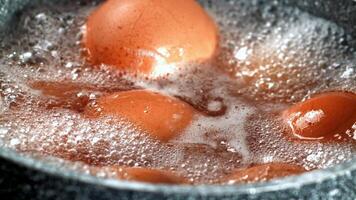 Super slow motion eggs are boiled in a saucepan. High quality FullHD footage video