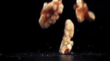 Super slow motion Walnuts fall on the table. High quality FullHD footage video