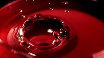 Super slow motion drop of wine falls into a glass of splashes. Macro background. Filmed on a high-speed camera at 1000 fps.High quality FullHD footage video