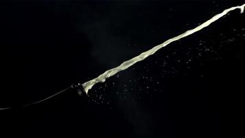 A bottle of champagne shoots a jet of air bubbles. On a black background. Filmed is slow motion 1000 fps. video