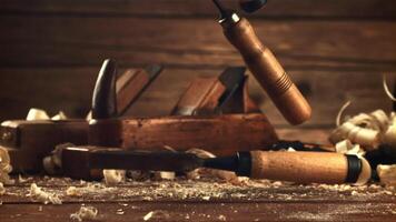 Chisels fall on a table of sawdust. On a wooden background. Filmed is slow motion 1000 frames per second.High quality FullHD footage video