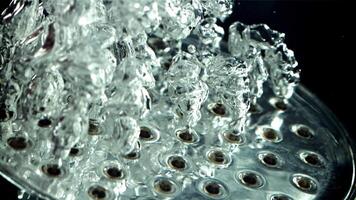 Air bubbles rise up under water from the shower head. Macro background. Filmed is slow motion 1000 fps. video