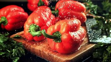 Drops of water fall on the sweet pepper and parsley. On a black background. Filmed is slow motion 1000 fps. video