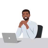 Young black man sitting at desk deep in thought working on laptop in office. vector