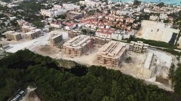 antenne visie van aanzienlijk gebouw plaats gelegen in toerist hub met visie van zee, compleet met toren kraan, gelegen in punta kana, dominicaans republiek. dar is in beweging langs een circulaire traject video