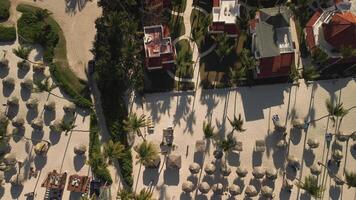 Overhead perspective of tropical tourist spot showcasing condos during sunset. Scene is adorned with lovely residences and palm trees. Dominican, Punta Cana, Los Corales video