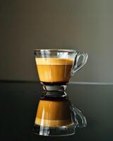 Coffee in Glass Cup on Wet Surface photo