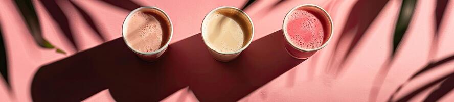 Some cups of smoothies, minimalist background, shadow leafs photo