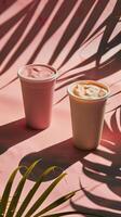 Some cups of smoothies, minimalist background, shadow leafs photo