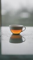 Steaming Tea Cup on Moist Surface photo