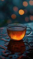 Steaming Tea Cup on Moist Surface photo