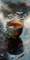 Steaming Tea Cup on Moist Surface photo