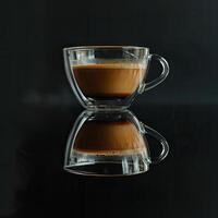 Coffee in Glass Cup on Wet Surface photo