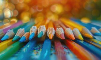 A distant view of colored pencils scattered on a tabletop photo