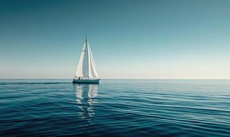 A sailboat gliding across the calm waters of the ocean photo