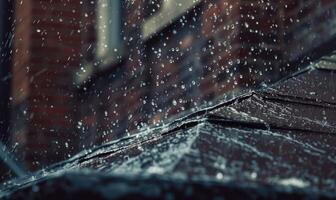 Raindrops cascading off the edge of a rooftop during a heavy downpour photo