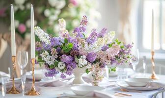 A floral arrangement featuring lilacs and laburnums on a dining table photo