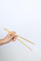 Female Hand Holding Chopstick photo