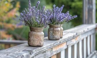 A weathered porch railing decorated with jars of lavender photo