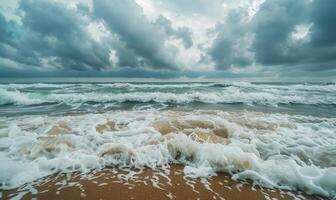 A rainy day at the beach, waves crashing against the shore and rain clouds looming overhead photo